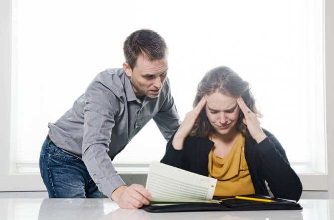 Man and woman stressed about finances