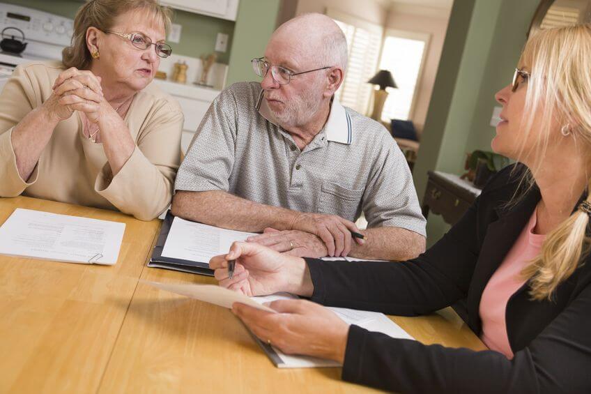 Elderly couple with financial advisor