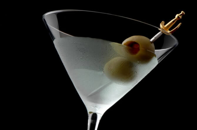 Martini Cocktail with Olives on Black