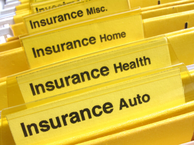 Yellow folders show different types of insurance papers