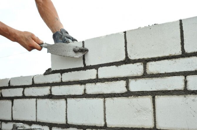 man stacking bricks