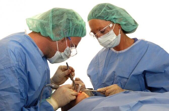 surgeon performing oral surgery