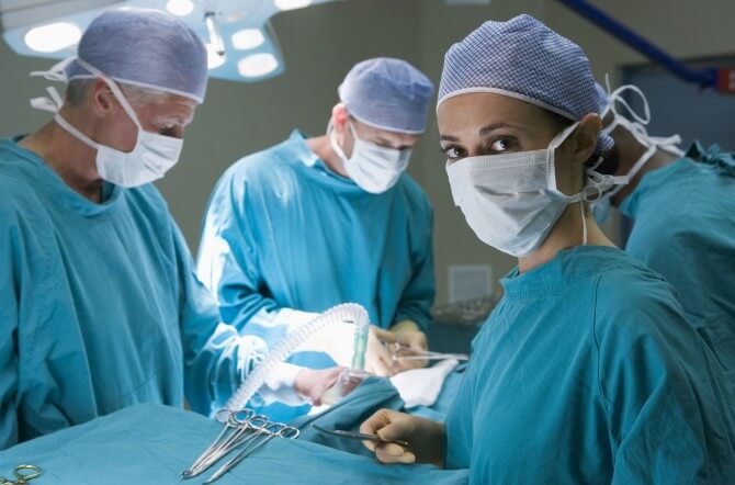 surgeons with masks in operating room