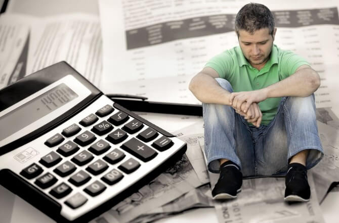 Man sitting on financial documents
