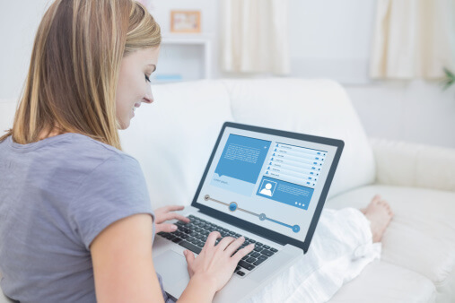 Woman sitting on couch and checking social media profile