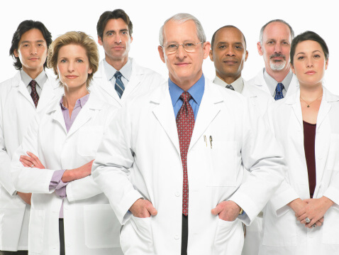Group portrait of doctors on white background