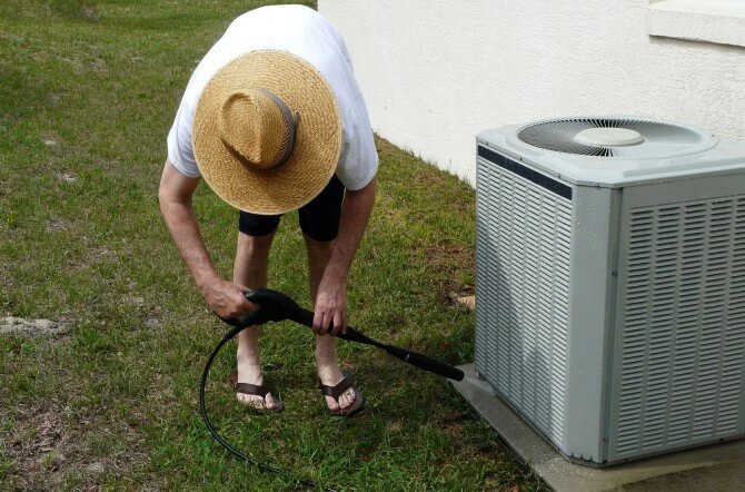 Man cleaning A/C Unit