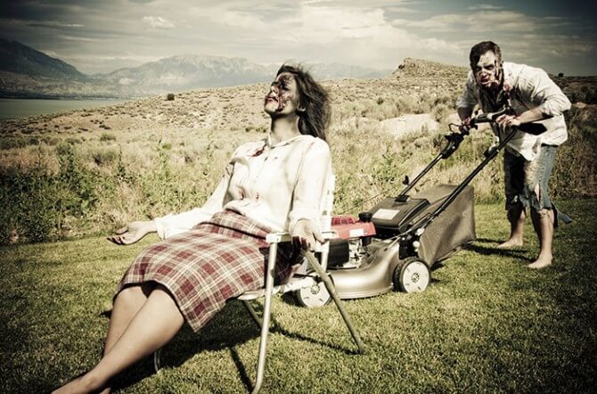 Zombie man mowing lawn while zombie wife relaxes