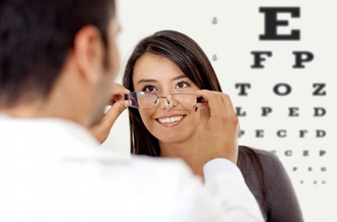 female patient in front of eye chart