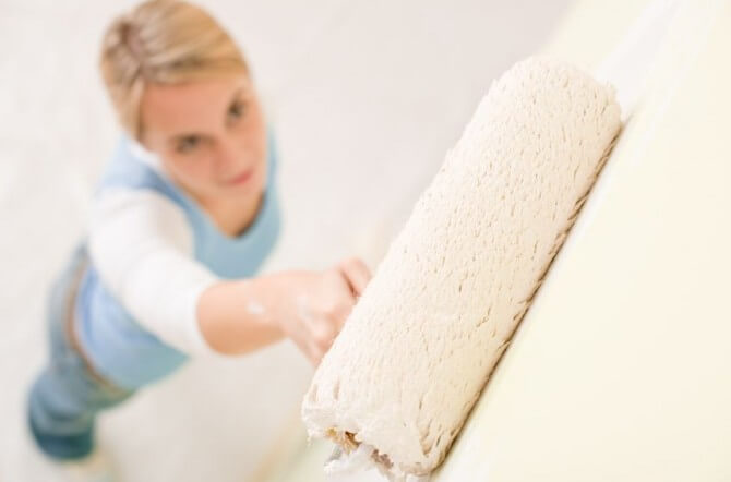 woman holding paint roller