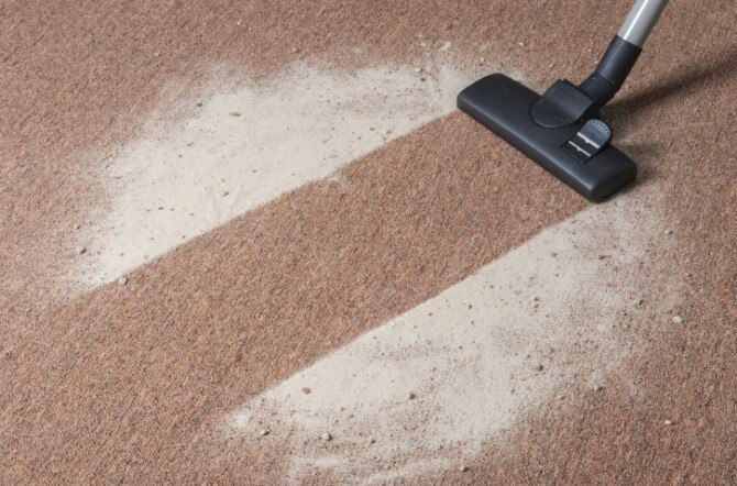 Vacuum cleaning dirt on a carpet