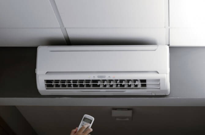 Hand controlling an air conditioner