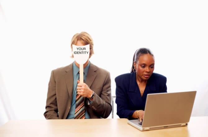 Man with mask and woman with laptop