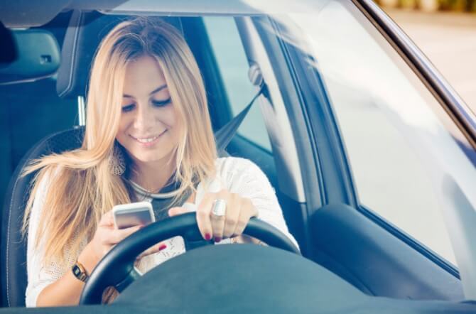 Young Woman Sending Messages while Driving