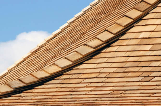 cedar roof with clouds in background