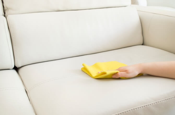 yellow towel wiping sofa