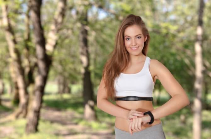 Young woman with fitness monitor